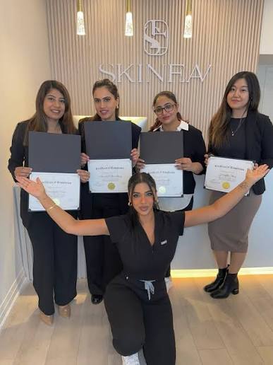 SKINEAV program graduates holding their certificates with Evelyn