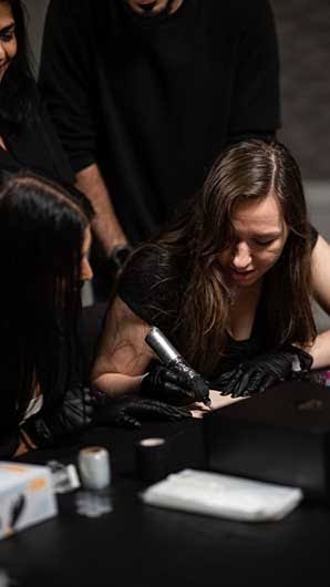 A SKINEAV student practicing hands-on on a live model